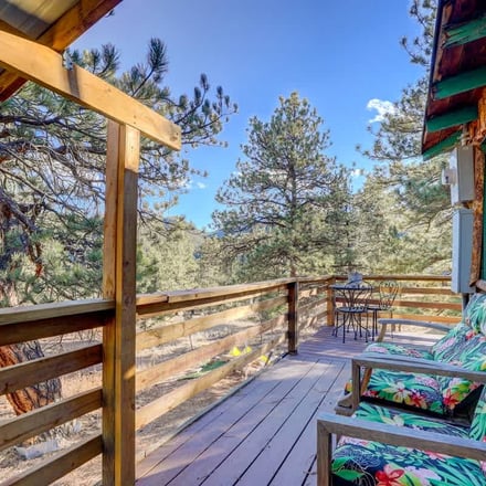 Pine cabin deck with mountain views through the ponderosa pines