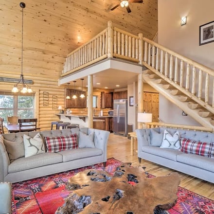 Alma cabin interior with loft, live-edge coffee table and Navajo rug