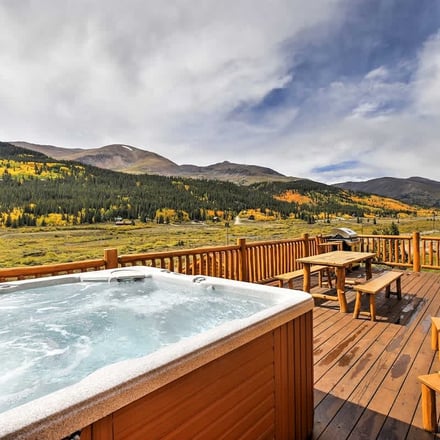Alma cabin exterior with golden aspen trees and mountain peaks in fall