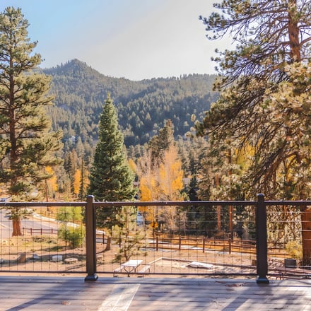 Stone lodge exterior with summer green hillside, Colorado